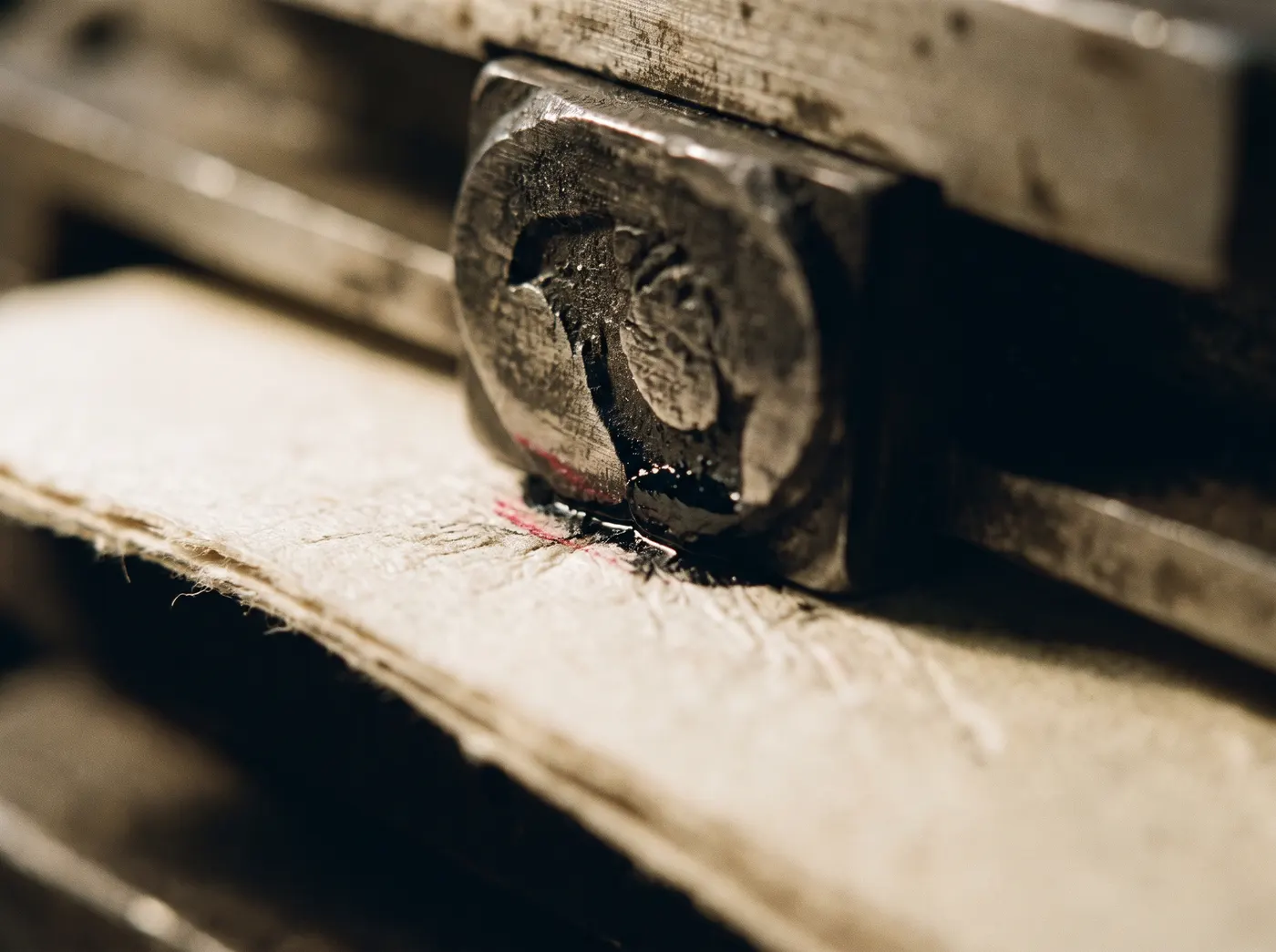 A letterpress die striking newsprint